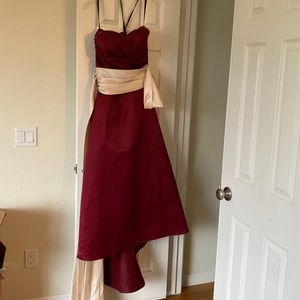 Bridesmaid dress in burgundy w cream belt and strapless top.
